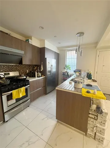 a kitchen with stainless steel appliances granite countertop a sink and a stove