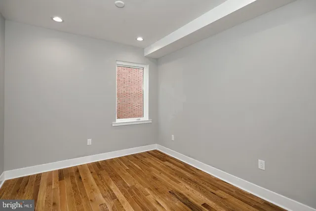 a view of room with wooden floor and fan