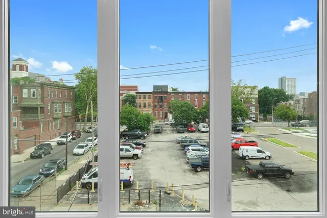 a view of a city from a corridor