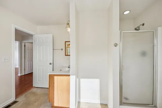 a bathroom with a tub shower and sink