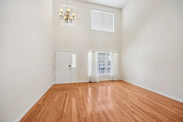 a view of a room with wooden floor and windows