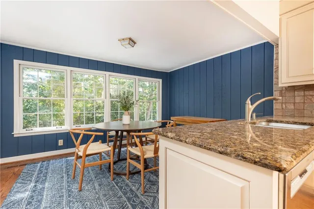 a kitchen with a stove a sink and a wooden cabinets