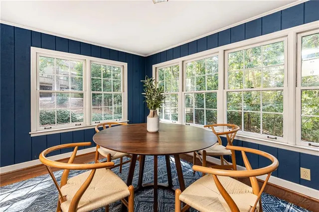 a dining room with furniture window and outside view