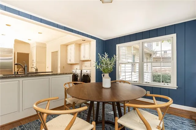 a dining room with furniture a window and wooden floor