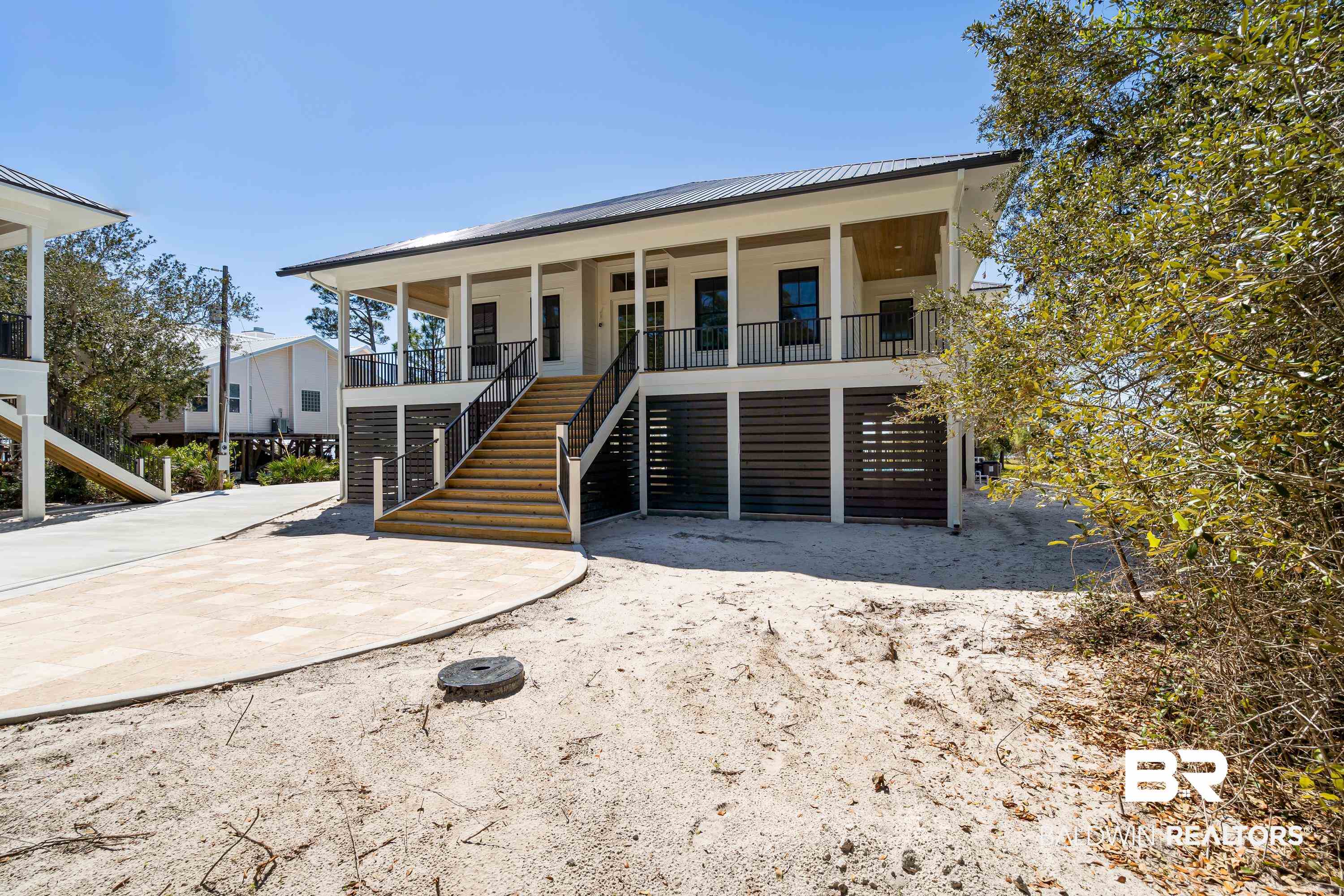 14686 State Highway Gulf Shores, AL 36542 - Photo 27 of 44 View of front of house featuring metal roof, a standing seam roof, stairway, and a porch