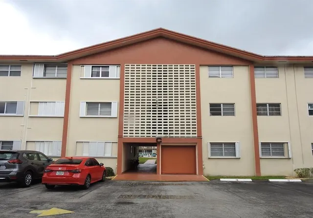 a front view of a house with parking space