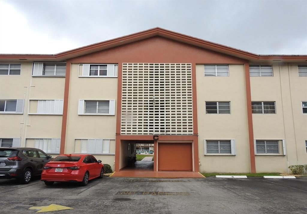 5300 Washington Street, Unit C213 Hollywood, FL 33021 - Photo 1 of 15 a front view of a house with parking space