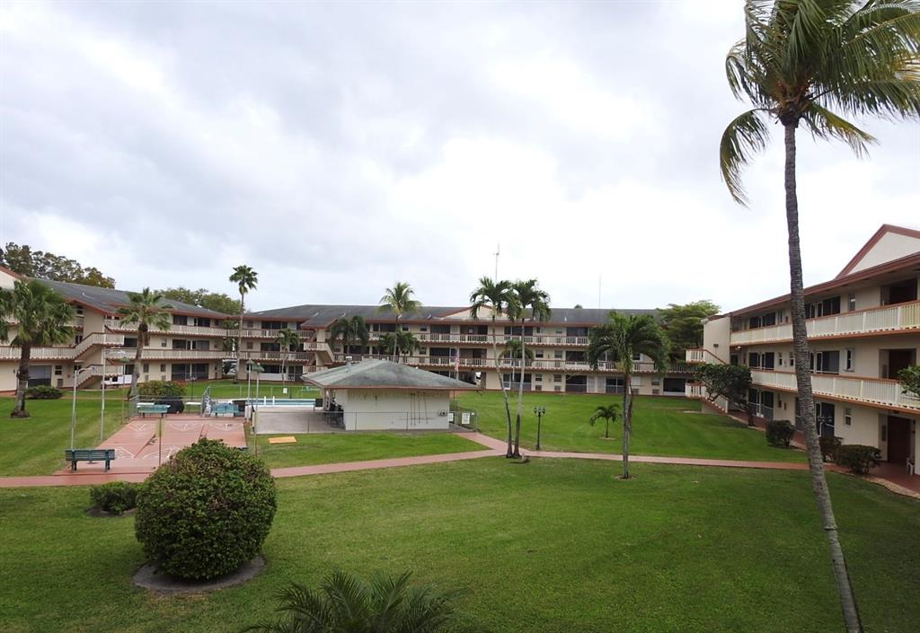 5300 Washington Street, Unit C213 Hollywood, FL 33021 - Photo 12 of 15 a view of a swimming pool with a yard