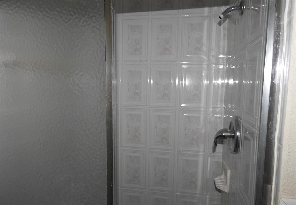 5300 Washington Street, Unit C213 Hollywood, FL 33021 - Photo 9 of 15 a bathroom with a glass shower door