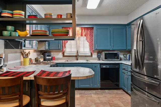 a kitchen with a sink a stove and a refrigerator