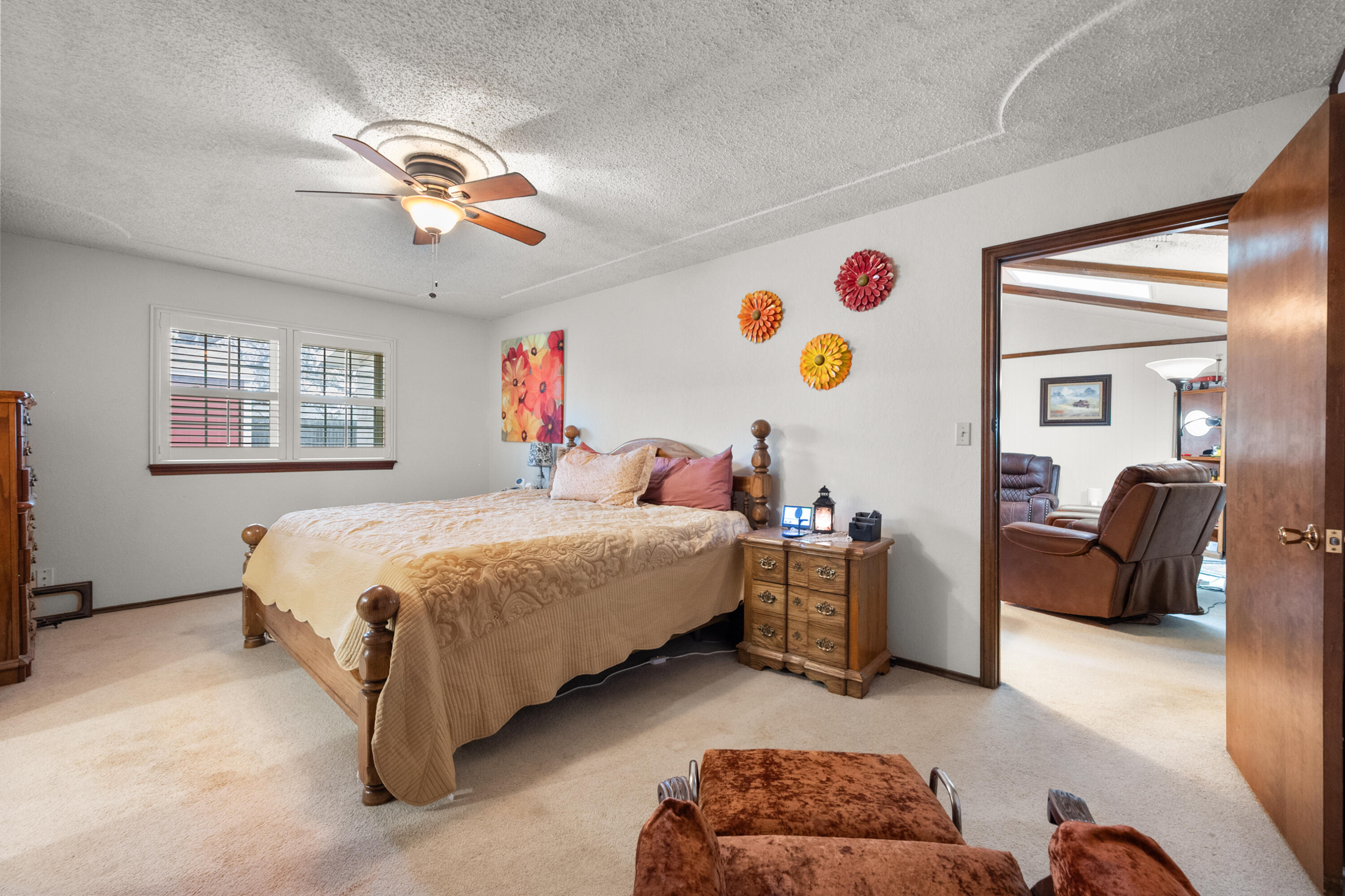 4610 63rd Street Lubbock, TX 79414 - Photo 21 of 30 a bedroom with a bed a couch and dresser