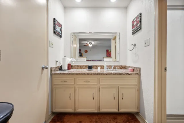 a bedroom with bed a gym equipment and a large window