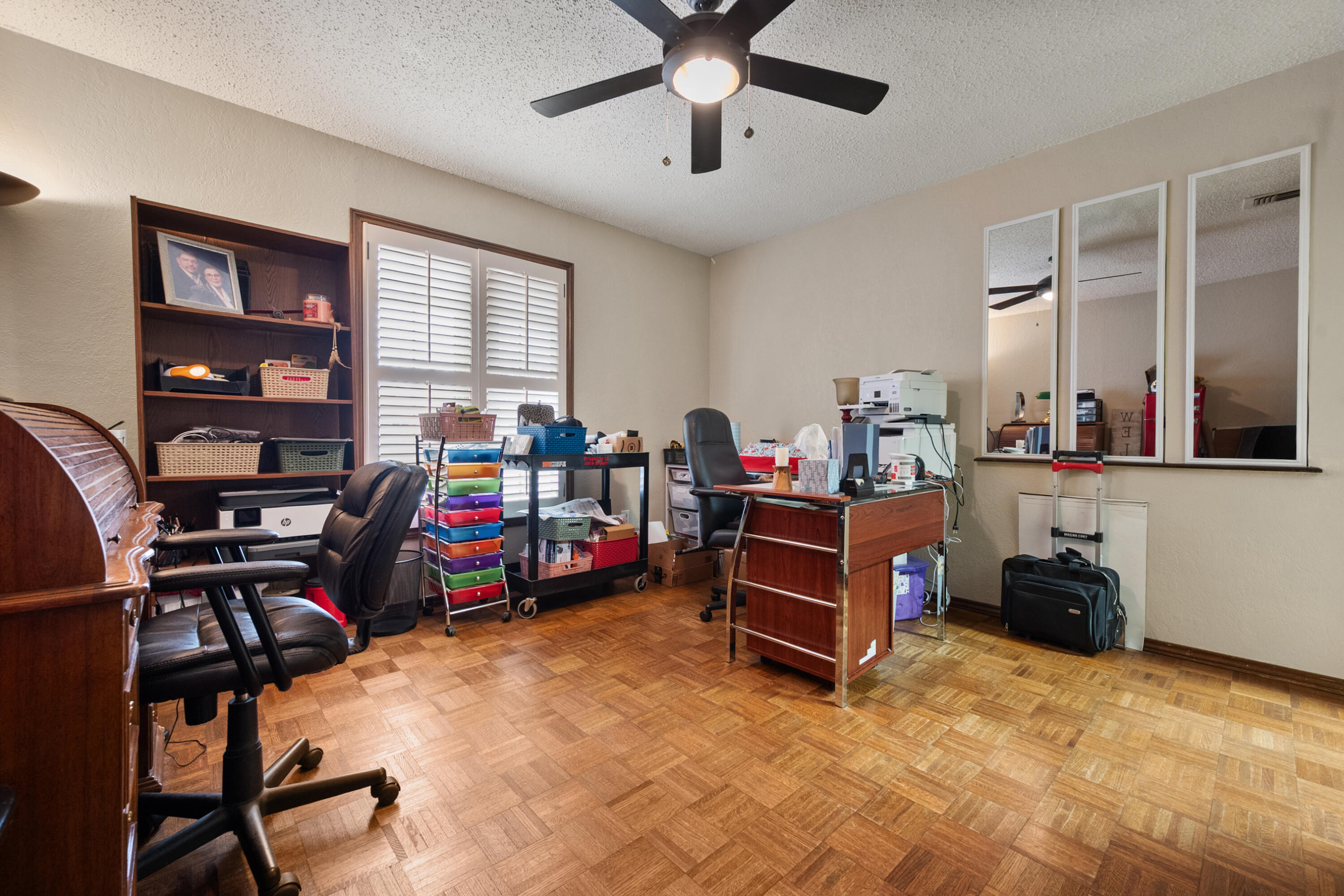 4610 63rd Street Lubbock, TX 79414 - Photo 24 of 30 a bedroom with bed a gym equipment and a large window