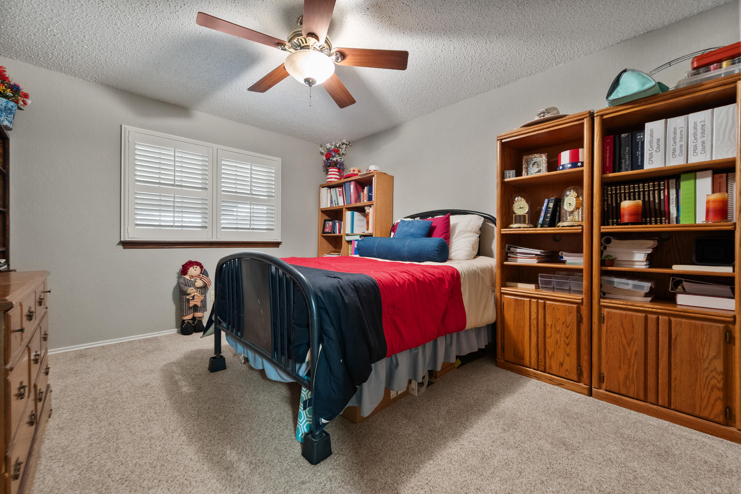 4610 63rd Street Lubbock, TX 79414 - Photo 26 of 30 a bedroom with a bed furniture and a chandelier