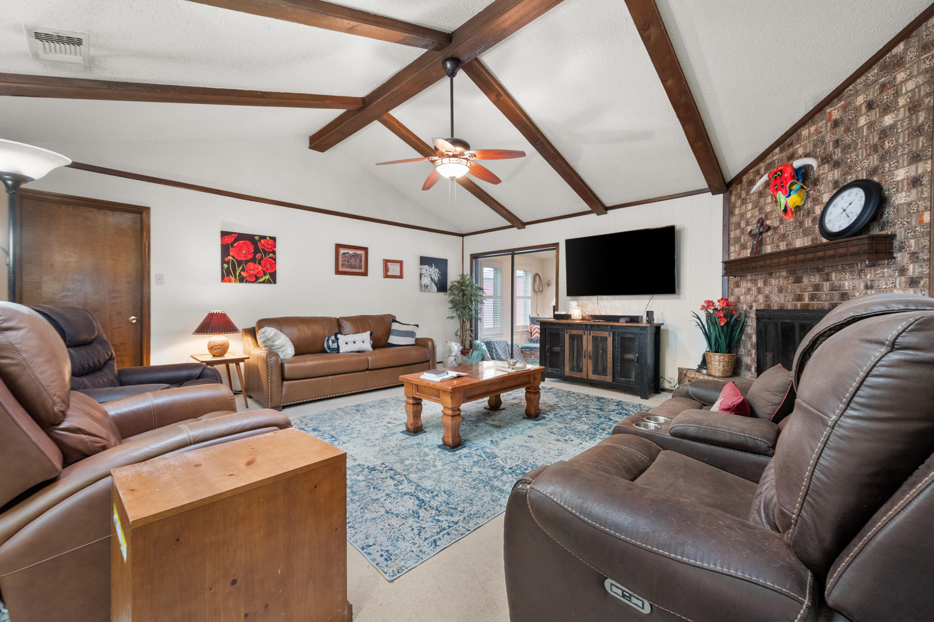 4610 63rd Street Lubbock, TX 79414 - Photo 8 of 30 a living room with furniture a flat screen tv and a couch