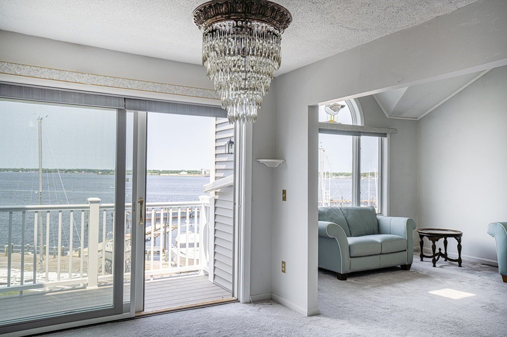 700 Shore Drive, Unit 511 Fall River, MA 02721 - Photo 4 of 40 a living room with furniture and a floor to ceiling window