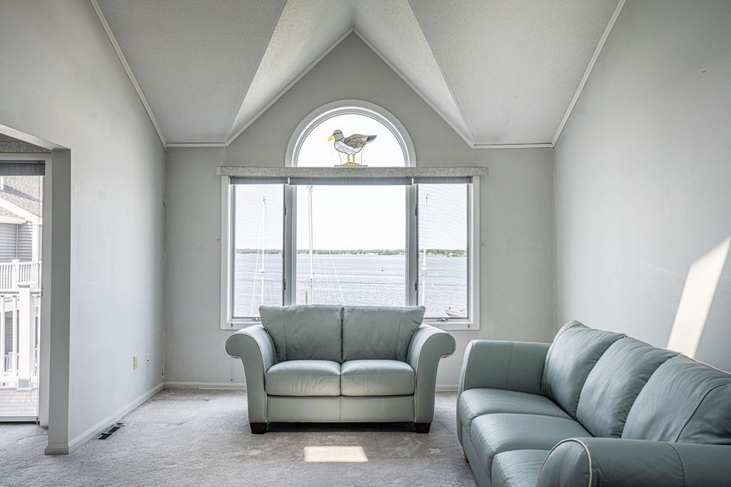 700 Shore Drive, Unit 511 Fall River, MA 02721 - Photo 5 of 40 a living room with furniture and a large window