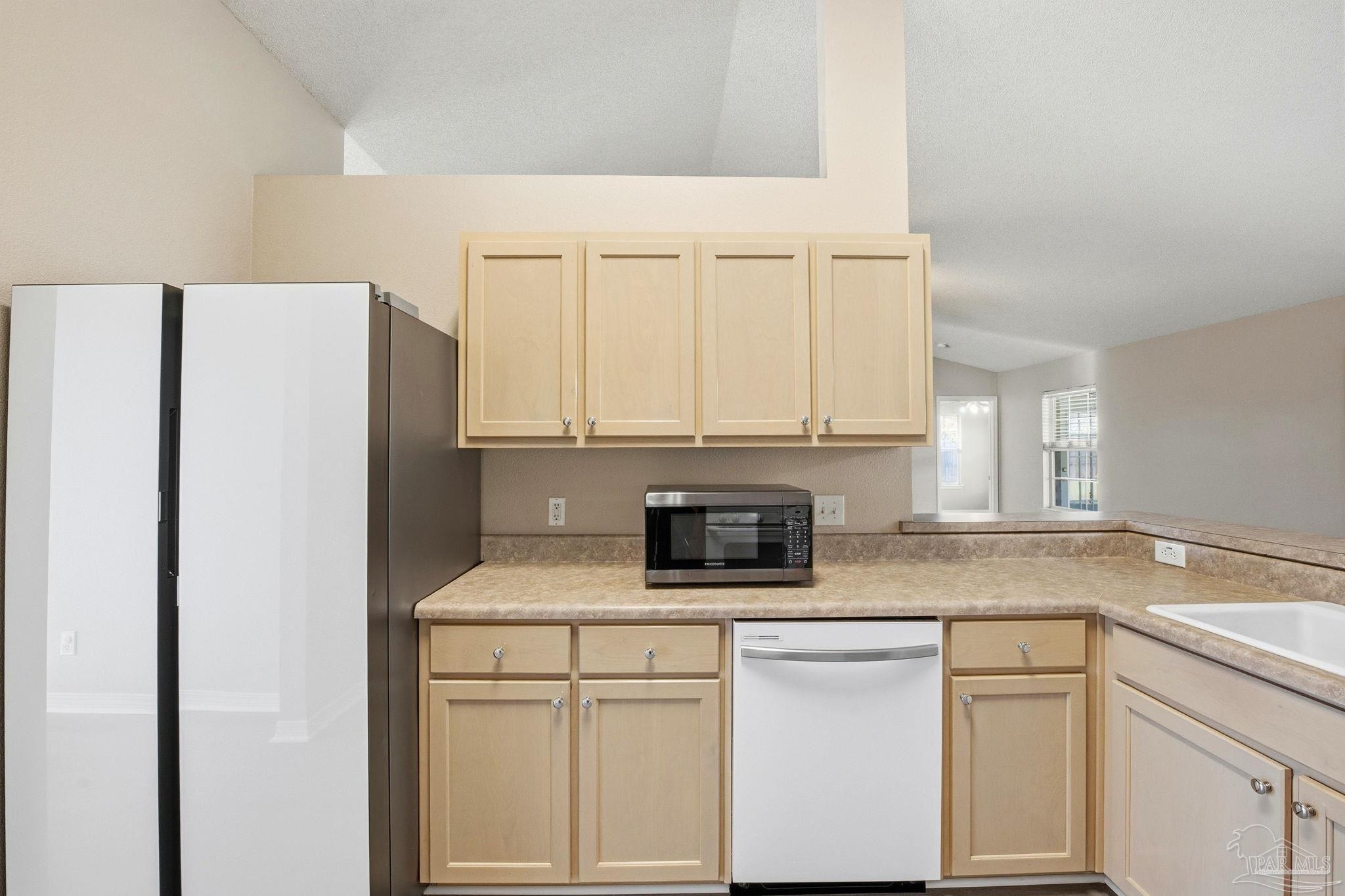 1844 Wareham Way Cantonment, FL 32533 - Photo 13 of 47 a kitchen with white cabinets and refrigerator