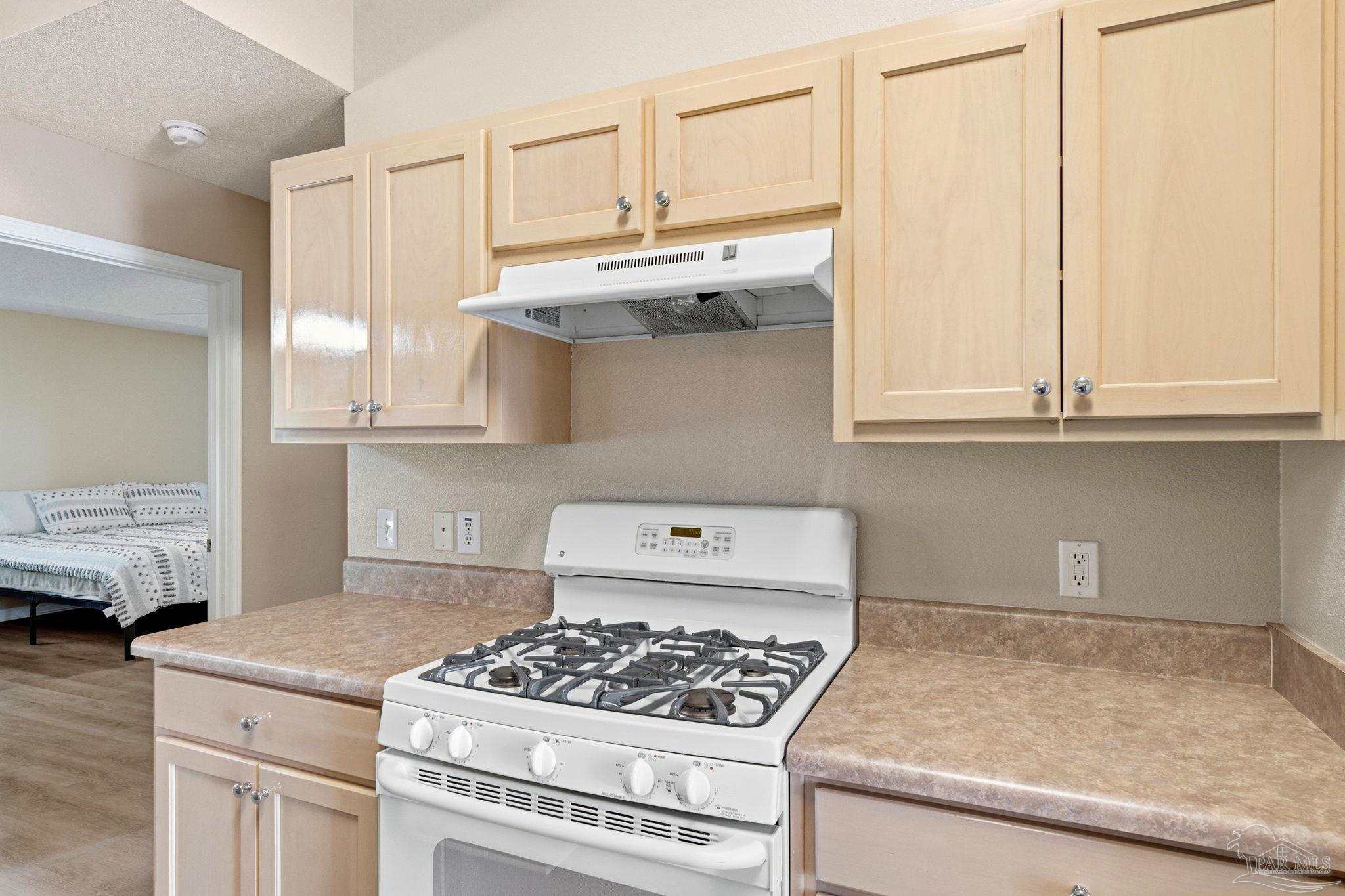 1844 Wareham Way Cantonment, FL 32533 - Photo 14 of 47 a kitchen with stainless steel appliances granite countertop a stove a sink and a white cabinets