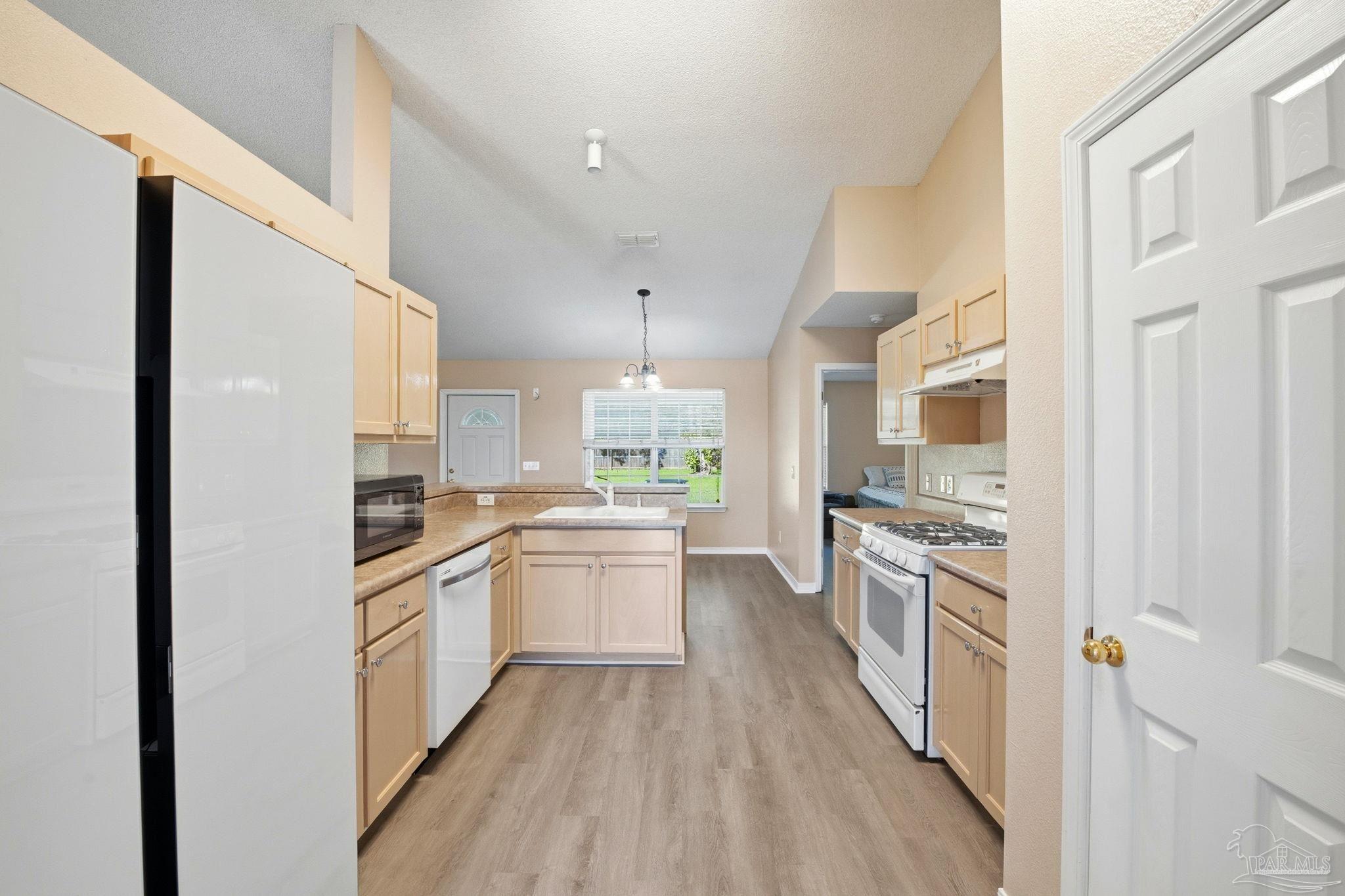 1844 Wareham Way Cantonment, FL 32533 - Photo 15 of 47 a kitchen with granite countertop a sink stove and refrigerator