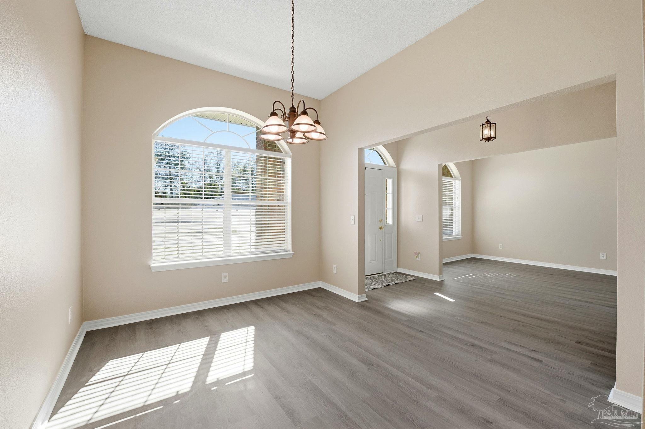 1844 Wareham Way Cantonment, FL 32533 - Photo 16 of 47 a view of an empty room with wooden floor and a window
