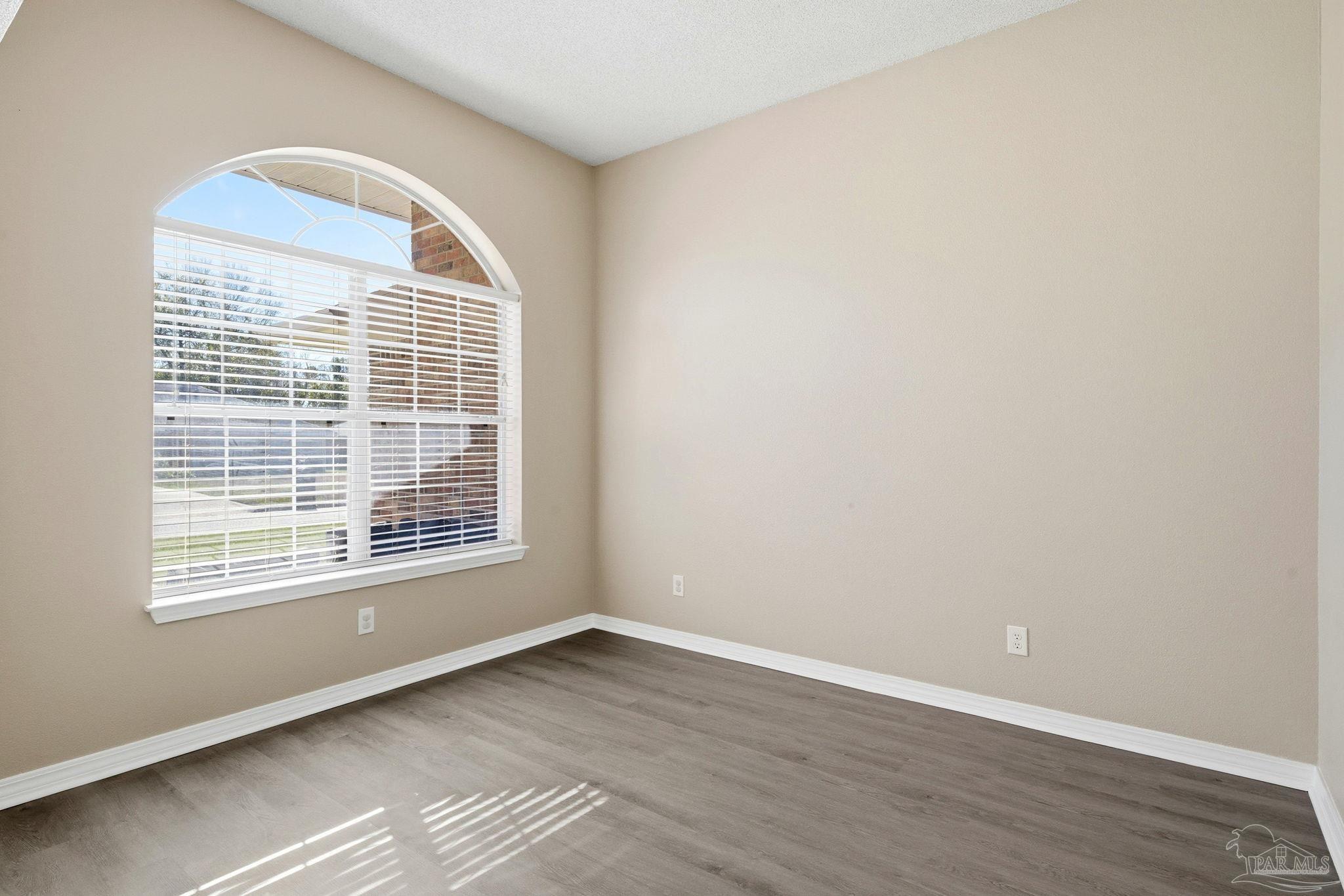1844 Wareham Way Cantonment, FL 32533 - Photo 19 of 47 a view of an empty room with wooden floor and a window