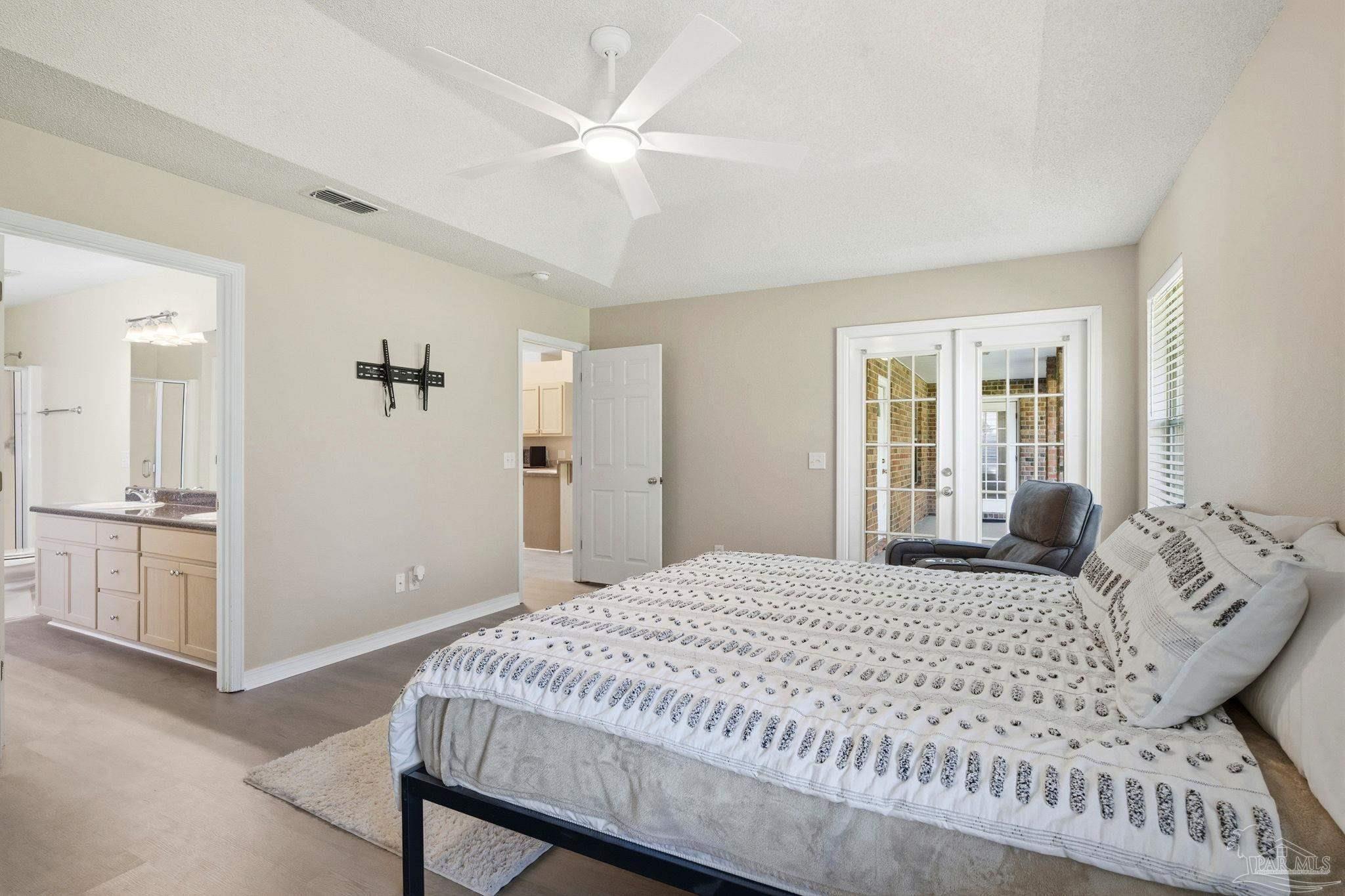 1844 Wareham Way Cantonment, FL 32533 - Photo 24 of 47 a bedroom with a bed and a chandelier