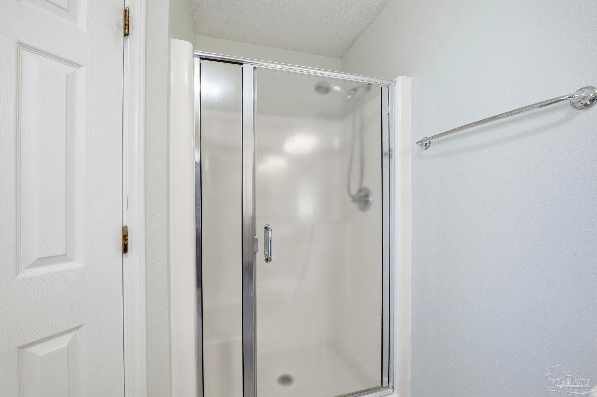 1844 Wareham Way Cantonment, FL 32533 - Photo 27 of 47 a bathroom with a glass shower door