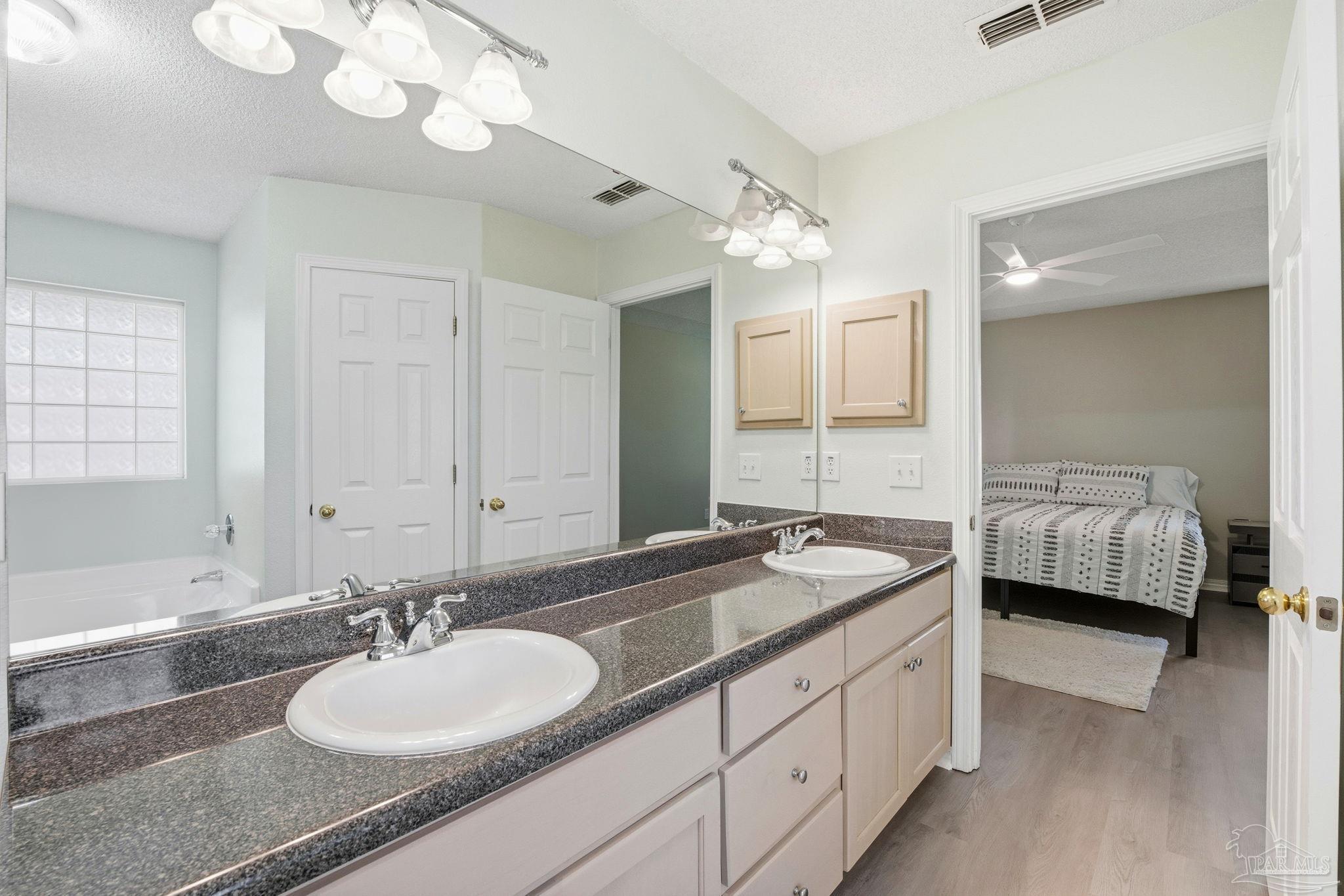 1844 Wareham Way Cantonment, FL 32533 - Photo 28 of 47 a en suite bathroom with a double vanity sink and a mirror