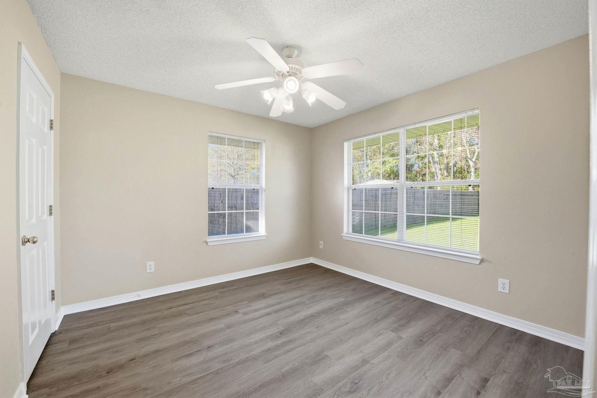 1844 Wareham Way Cantonment, FL 32533 - Photo 30 of 47 a view of an empty room with wooden floor and a window