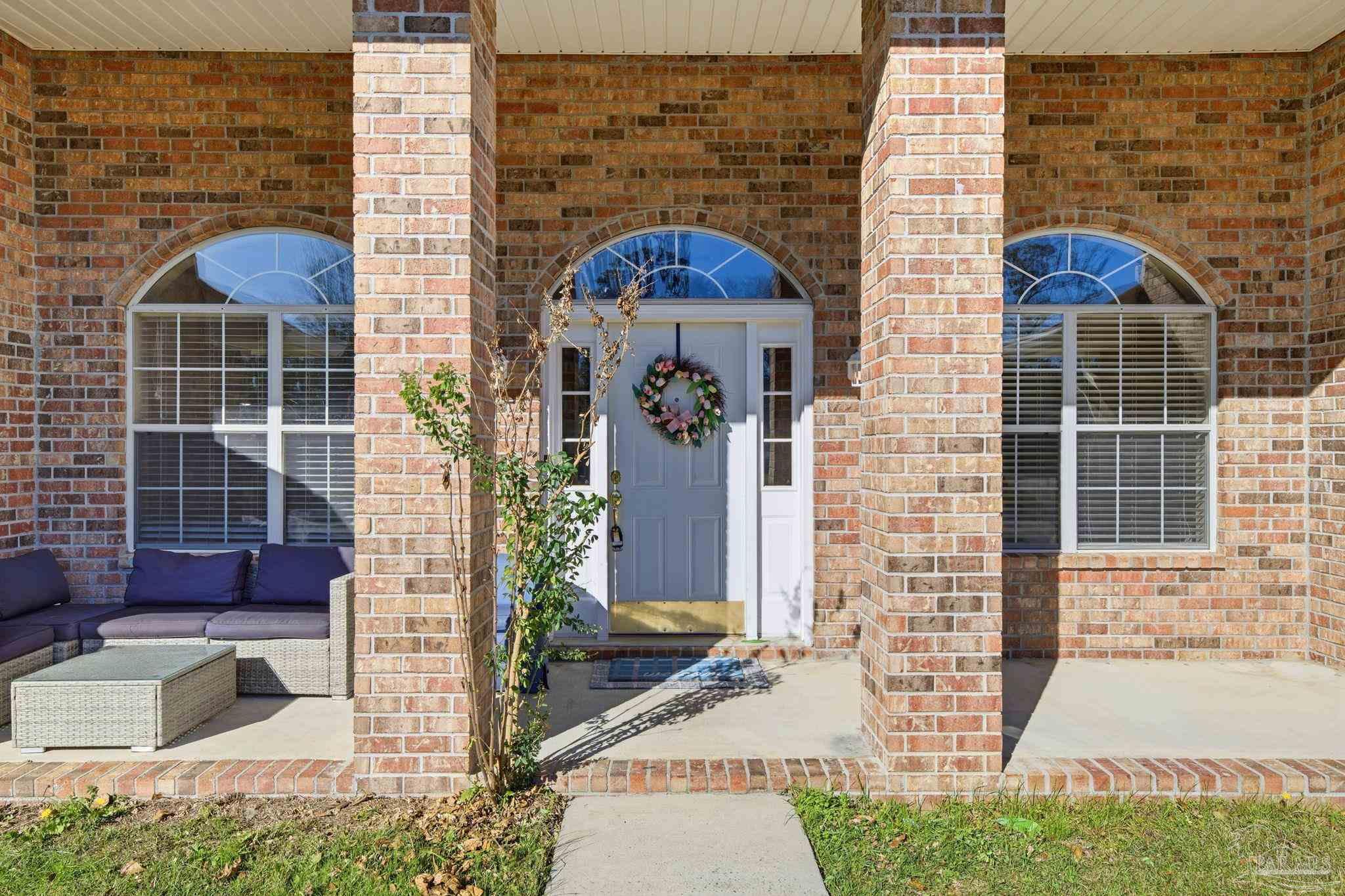1844 Wareham Way Cantonment, FL 32533 - Photo 3 of 47 a front view of a house with a garden