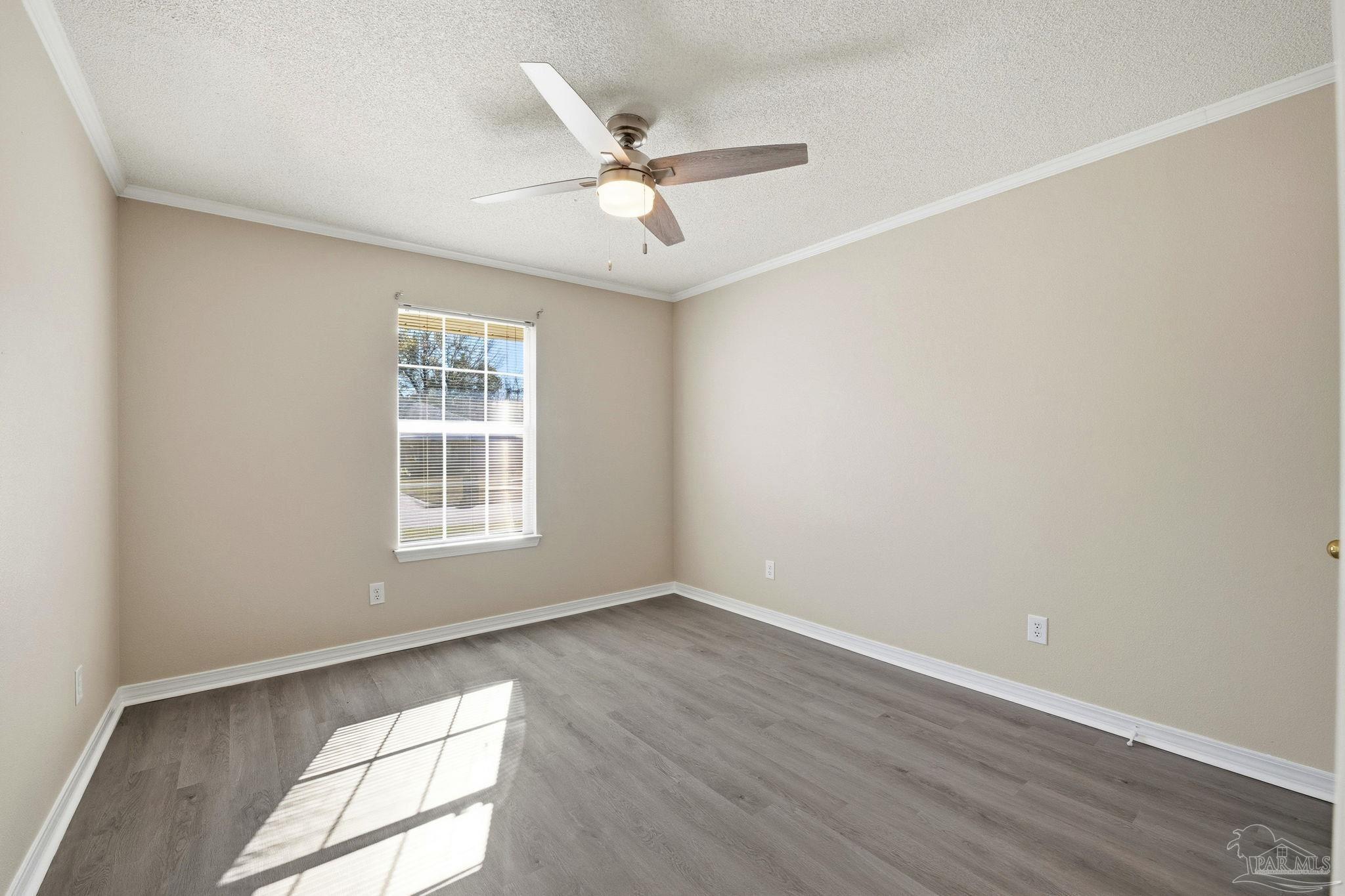 1844 Wareham Way Cantonment, FL 32533 - Photo 36 of 47 an empty room with wooden floor fan and windows