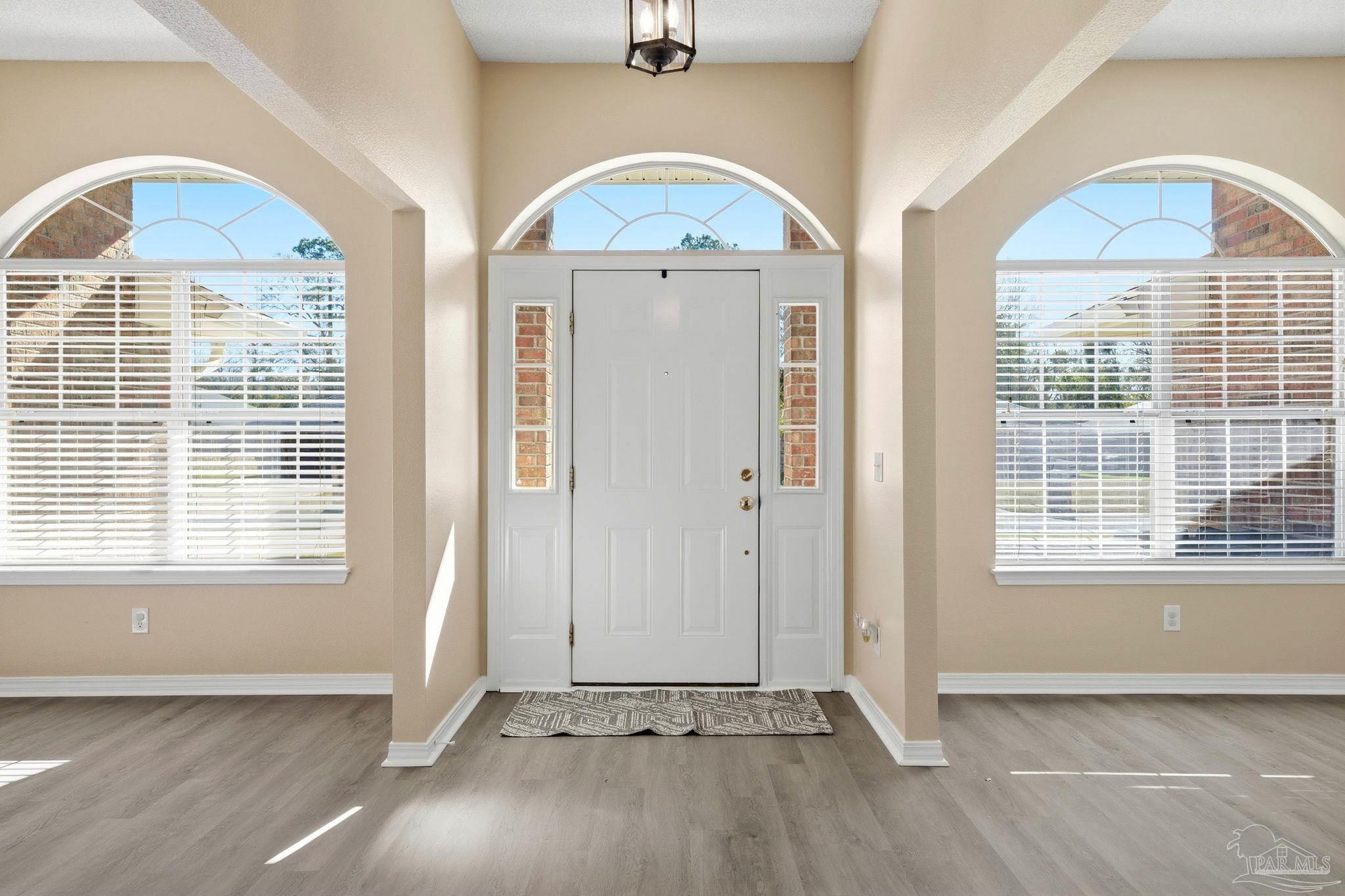 1844 Wareham Way Cantonment, FL 32533 - Photo 4 of 47 an empty room with a window and wooden floor