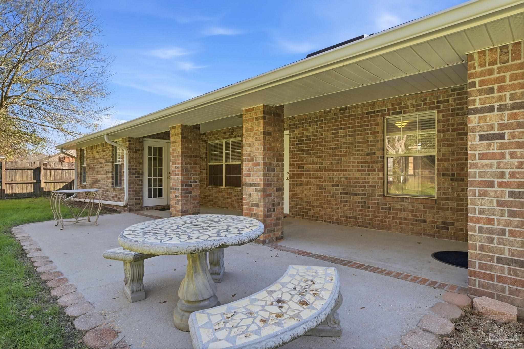 1844 Wareham Way Cantonment, FL 32533 - Photo 41 of 47 a view of a chairs and table in backyard of the house