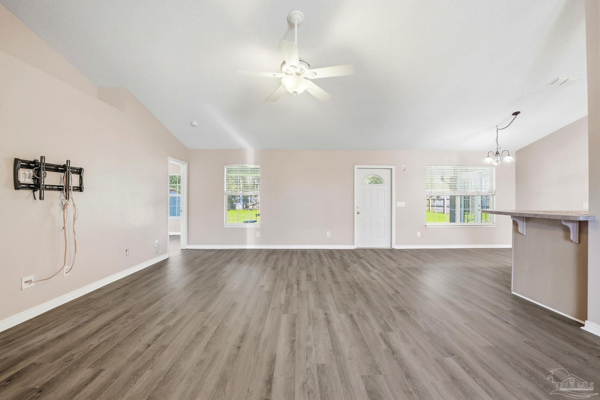 1844 Wareham Way Cantonment, FL 32533 - Photo 6 of 47 an empty room with wooden floor and windows