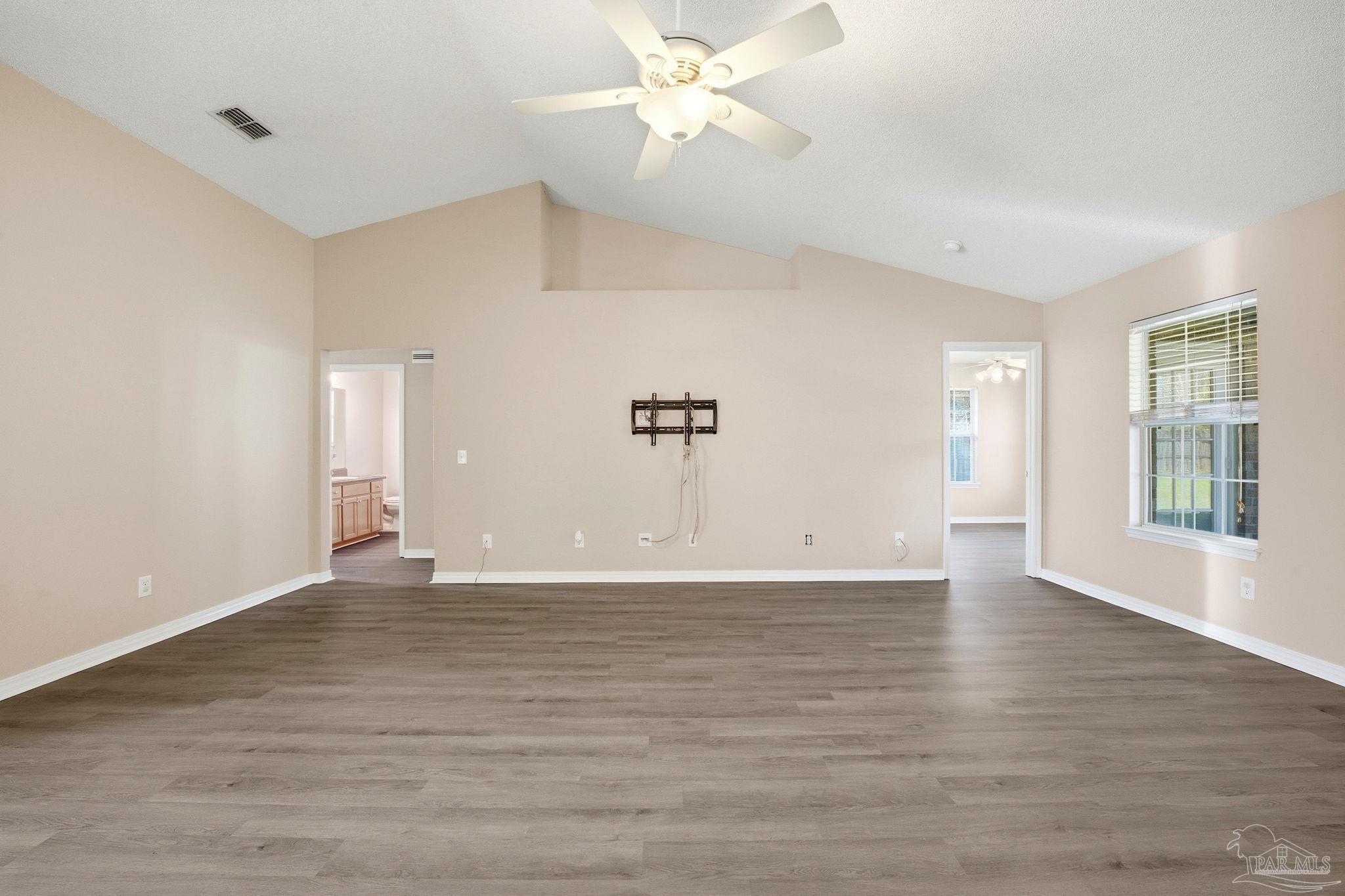 1844 Wareham Way Cantonment, FL 32533 - Photo 8 of 47 a view of an empty room with window and wooden floor