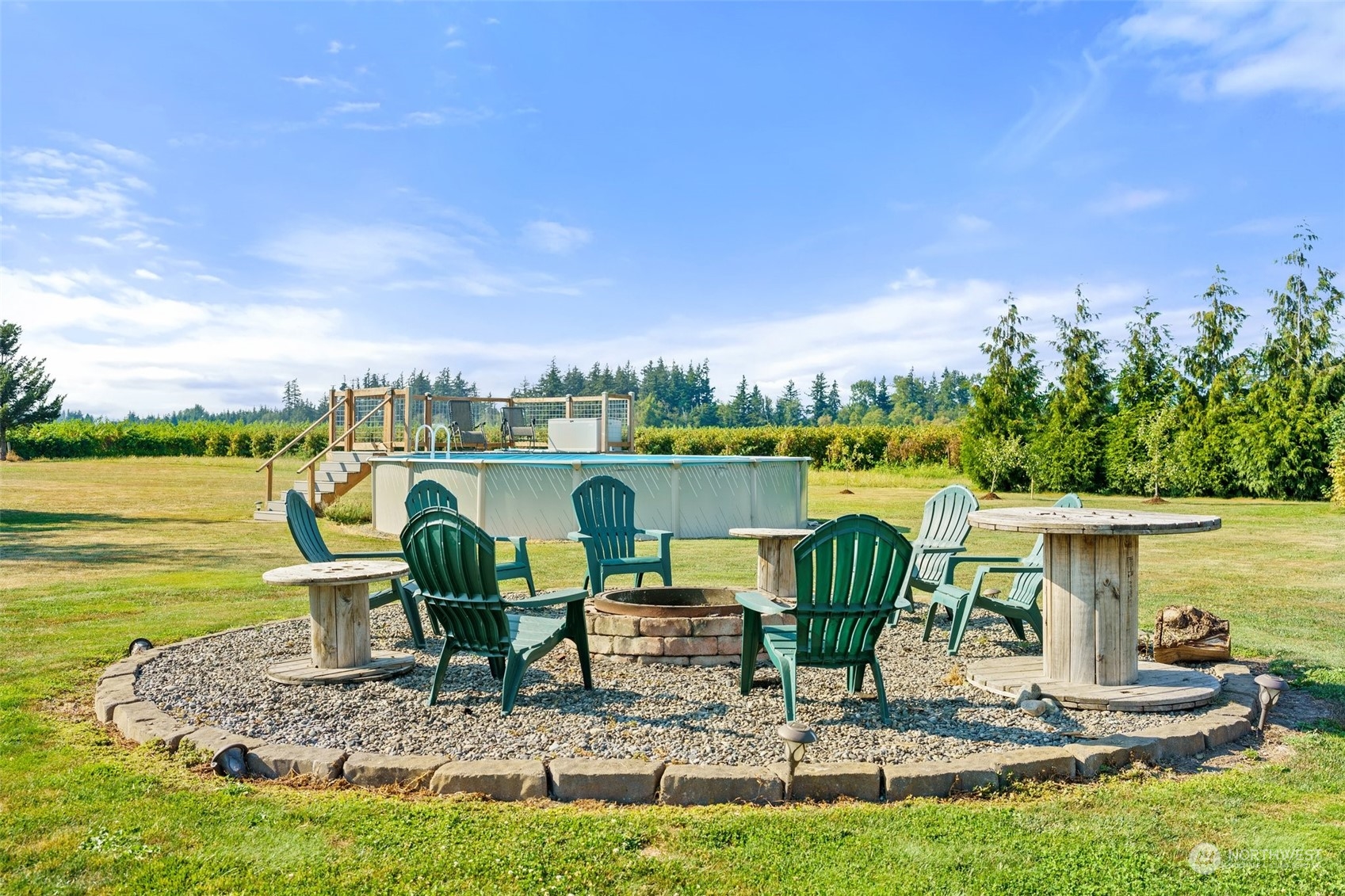 1880 Birch Bay Lynden Road Ferndale, WA 98248 - Photo 30 of 33 a view of a lake with table and chairs potted plants and large tree
