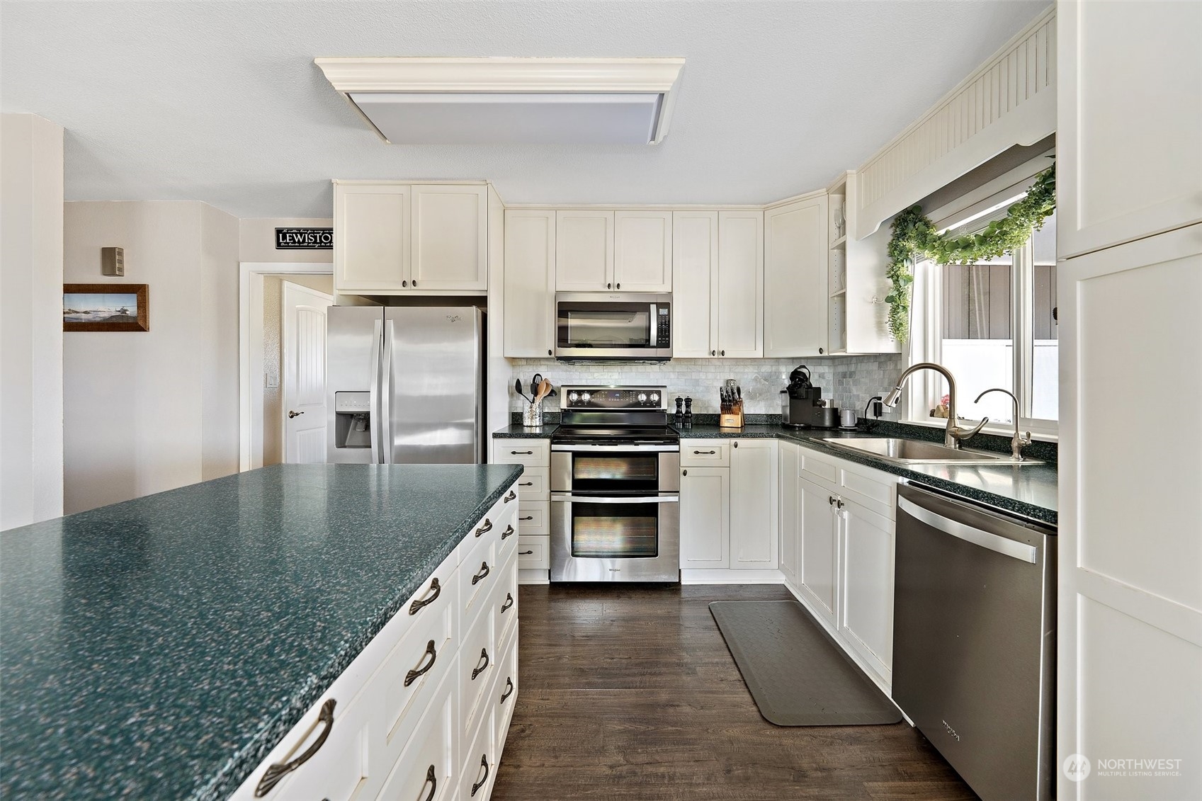 1880 Birch Bay Lynden Road Ferndale, WA 98248 - Photo 3 of 33 a kitchen with granite countertop a stove top oven a sink dishwasher a refrigerator and white cabinets with wooden floor