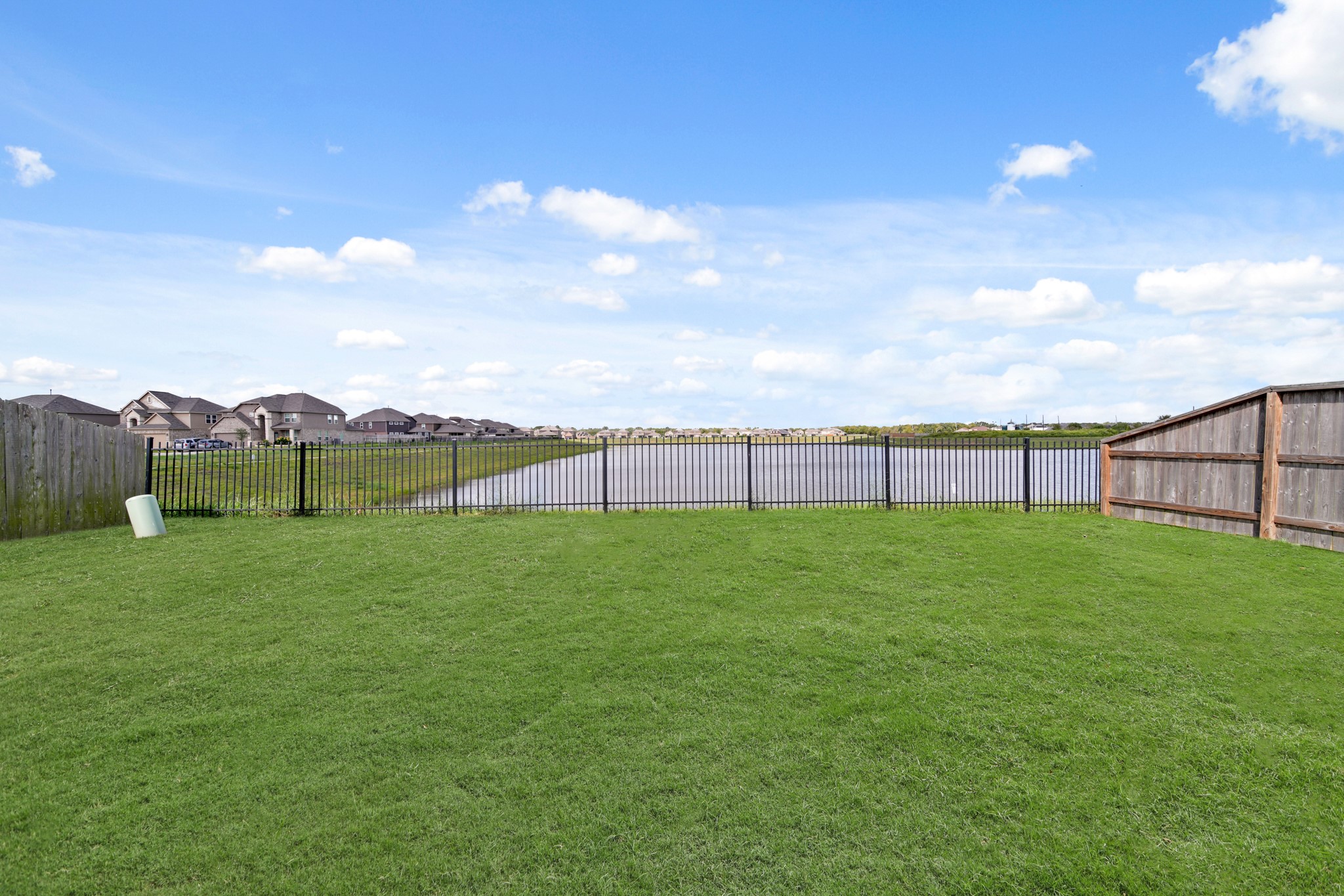 8802 Mallow Rose Way Rosharon, TX 77583 - Photo 26 of 29 This backyard has a metal fence for more privacy, and there is a magnificent view of the lake.