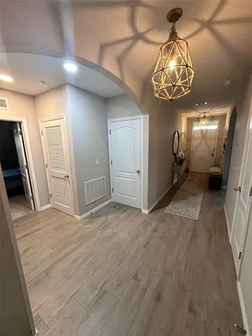 a view of a hallway with wooden floor