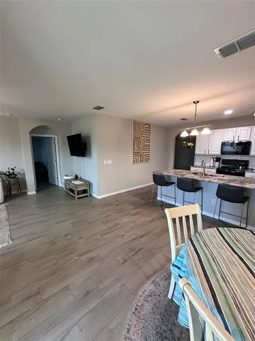 a living room with furniture and a kitchen view