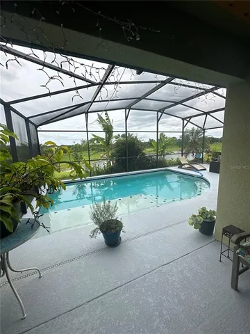 a porch with a table and chairs and potted plants