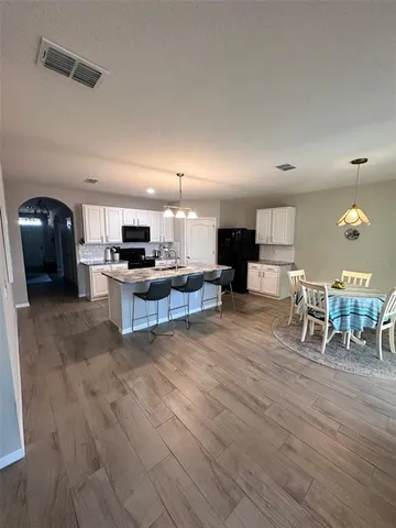 a living room with furniture and kitchen view