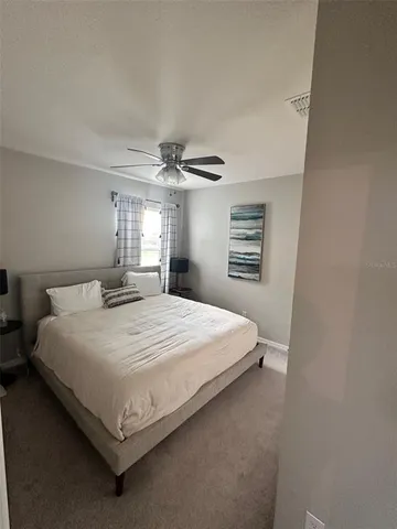 a bedroom with a large bed and a chandelier