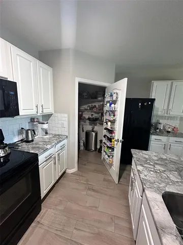 a kitchen with a stove and a refrigerator