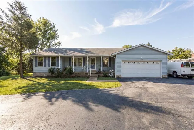 a view of a house with a swimming pool and a yard