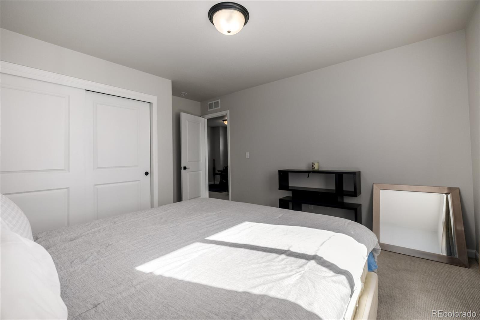 1875 Rancher Drive Milliken, CO 80543 - Photo 20 of 50 a bedroom with a bed and a television
