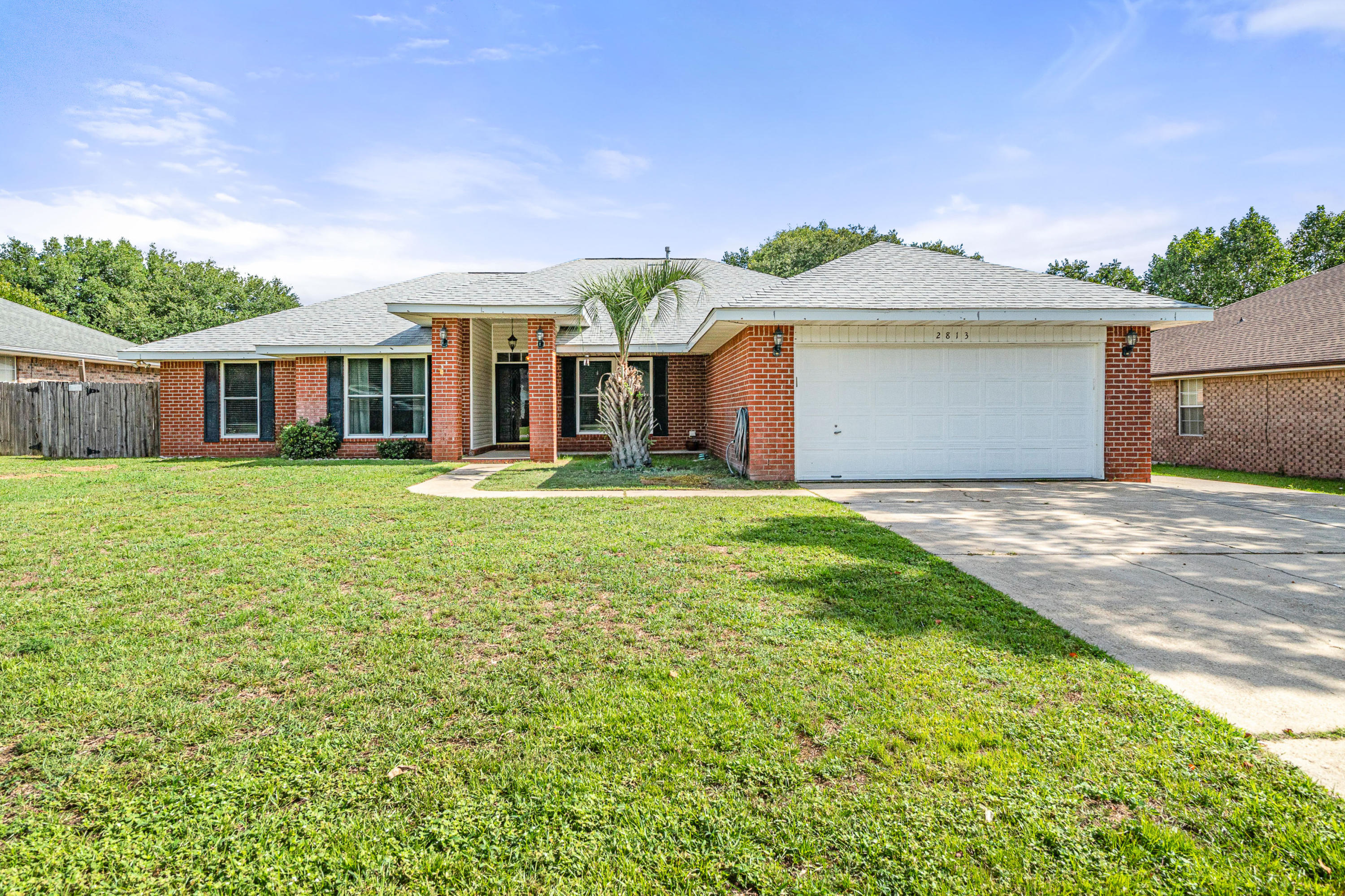 2813 Atoka Trail Crestview, FL 32539 - Photo 1 of 29 a front view of a house with a garden and yard