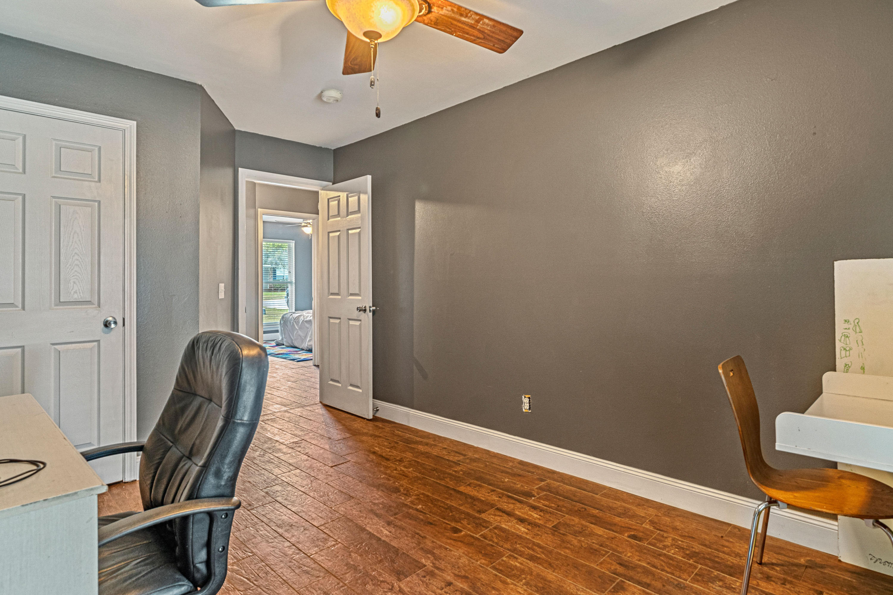 2813 Atoka Trail Crestview, FL 32539 - Photo 13 of 29 a view of a room with wooden floor and windows