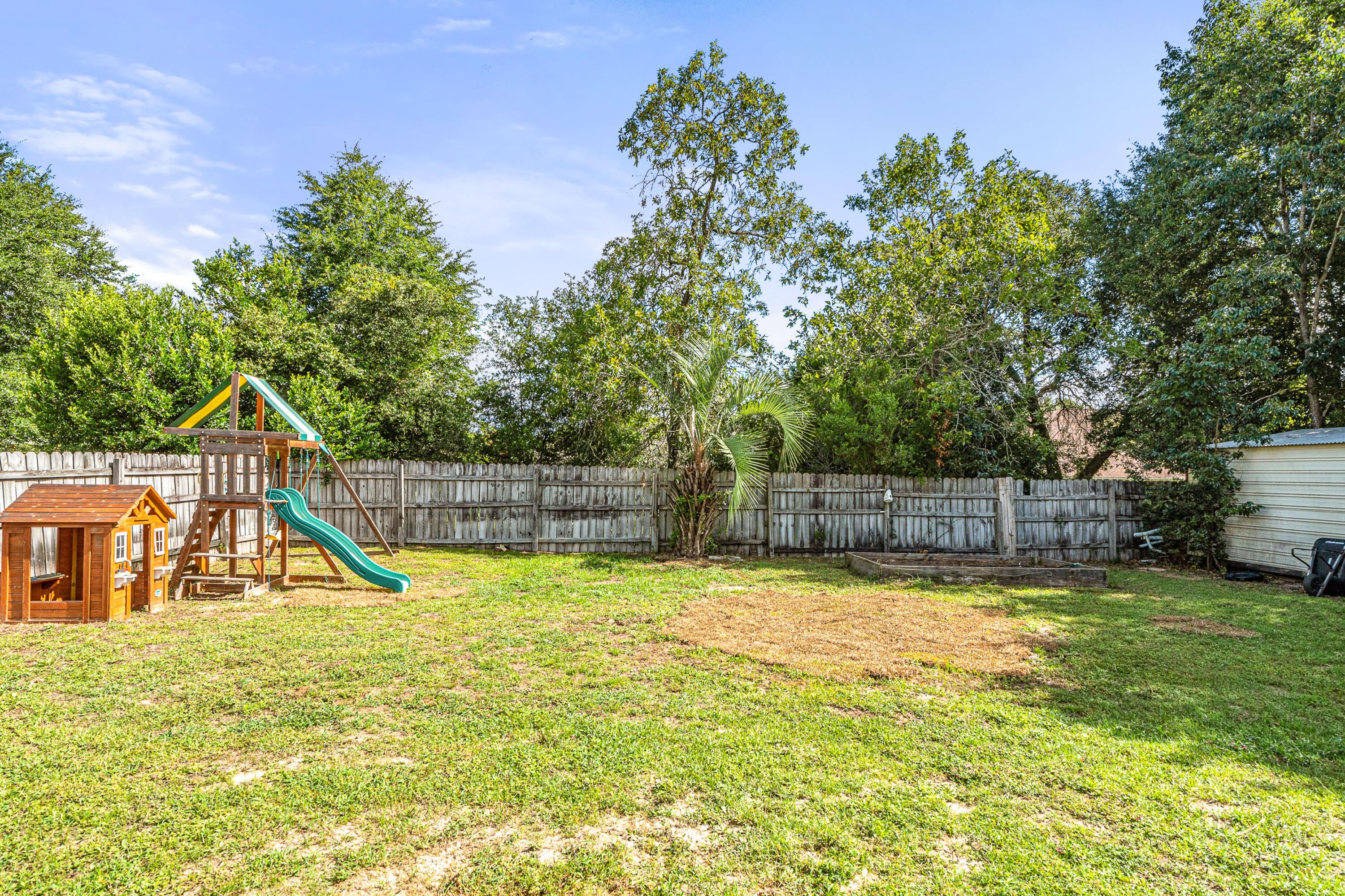 2813 Atoka Trail Crestview, FL 32539 - Photo 27 of 29 a view of a swimming pool with a slide and a small yard